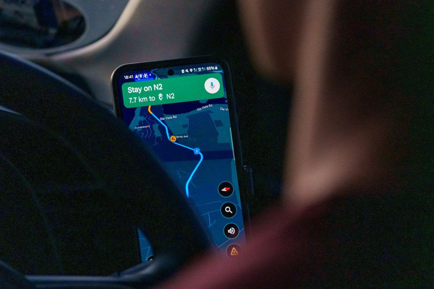 Customer using Google Maps navigation on a smartphone to find a local business