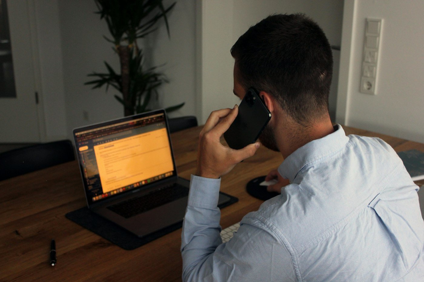 Business owner taking a lead call at his laptop